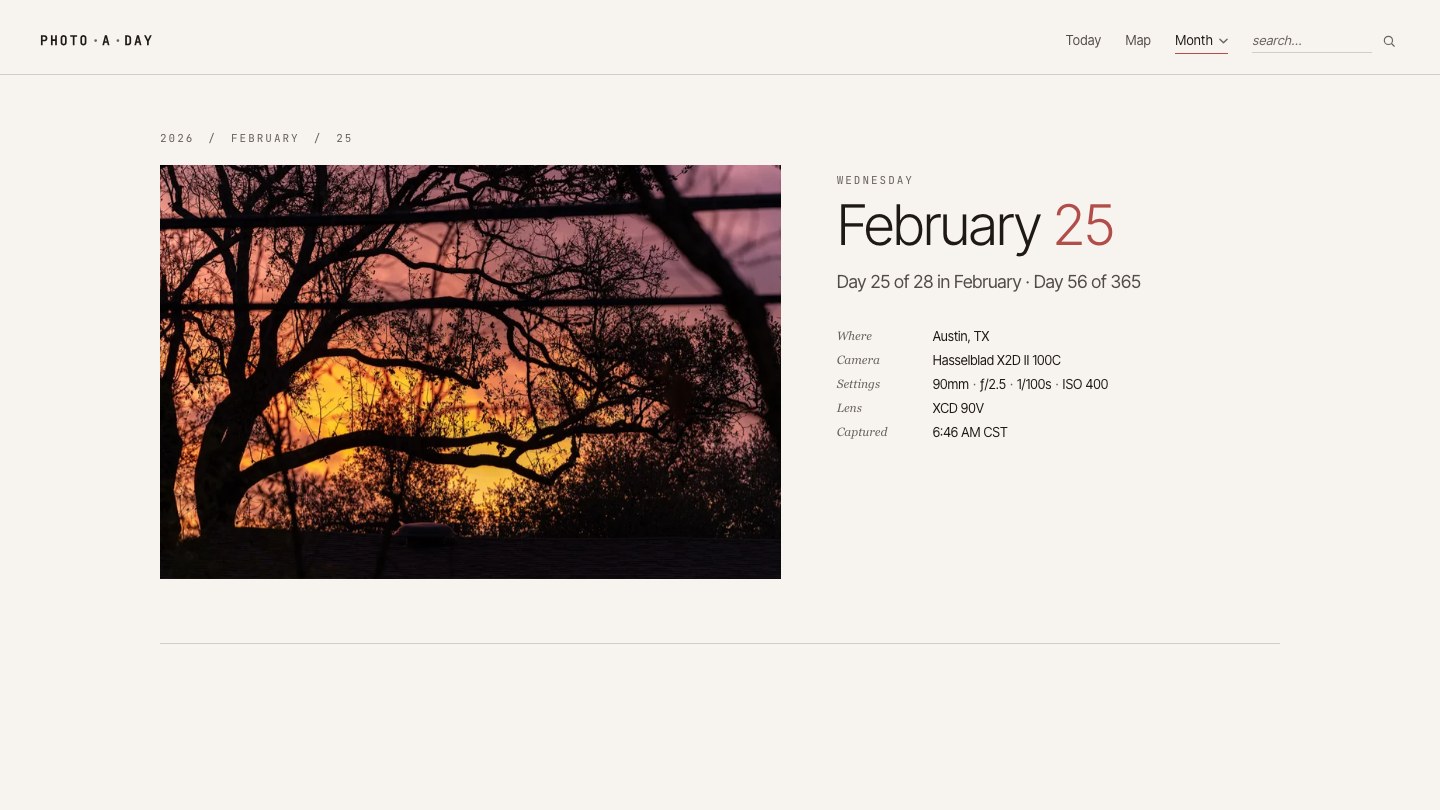 A screenshot of a single-day page on justmenotai.com — a sunset photograph in orange and purple tones with silhouetted tree branches, with the date "February 25", a "Day 56 of 365" subtitle, and an EXIF metadata strip (Austin TX, Hasselblad X2D II, 90mm, f/2.5).